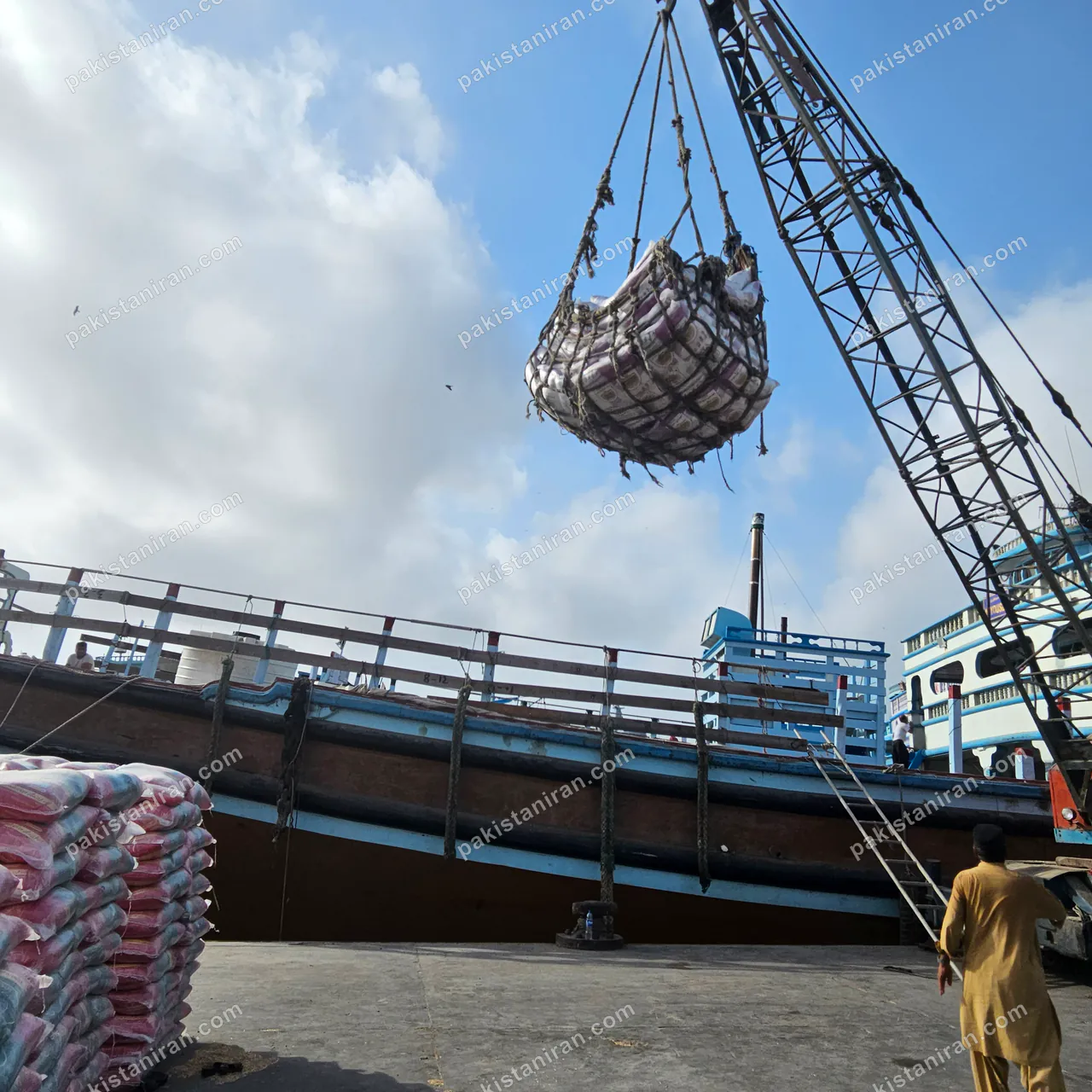HAS Trading shipment: Crane hoists a sling of rice bags aboard the launch